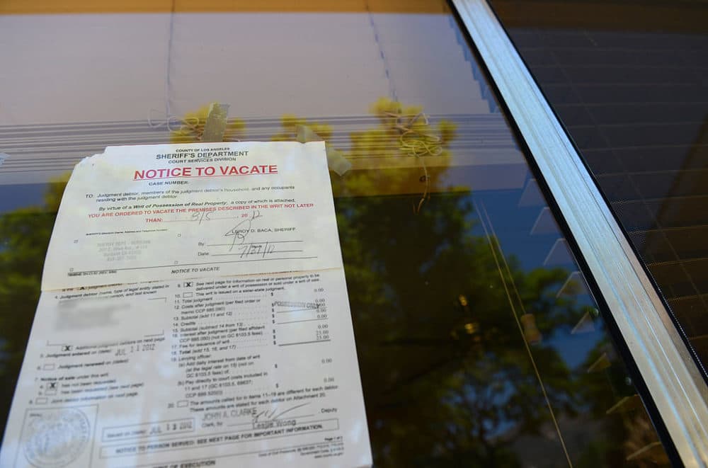 A "Notice to Vacate" is seen in the window of a home in Glendale, California. (Robyn Beck/AFP/Getty Images) 