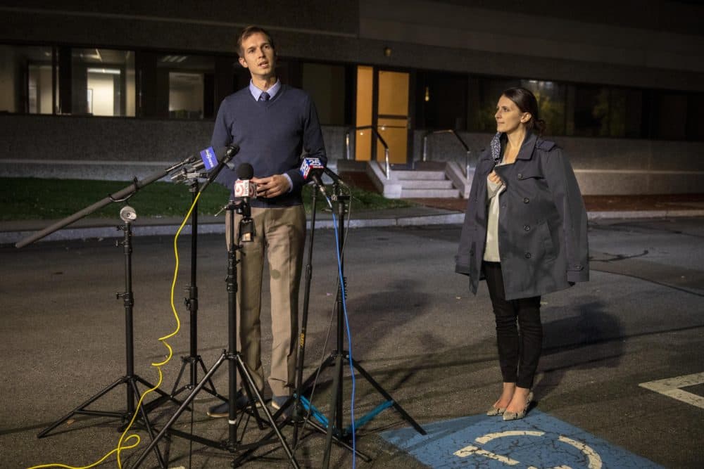 Standing with his wife Michelle, Democratic candidate Jake Auchincloss declares victory in Massachusetts' 4th Congressional District on Tuesday night. (Robin Lubbock/WBUR)