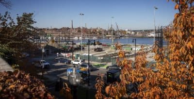 The view from Langone Park under construction, looking across the harbor to Bunker Hill and the USS Constitution. (Robin Lubbock/WBUR)