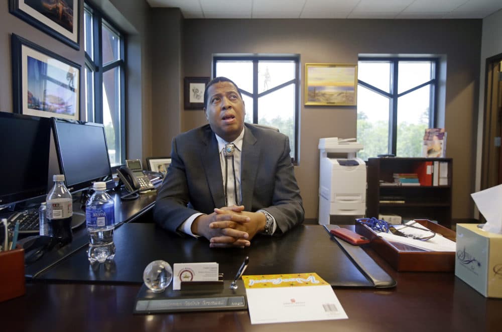 In this May 29, 2014 photo, Mashpee Wampanoag Tribe Chairman Cedric Cromwell sits behind his desk at the community/government Center in Mashpee, Mass. (Stephan Savoia/AP)