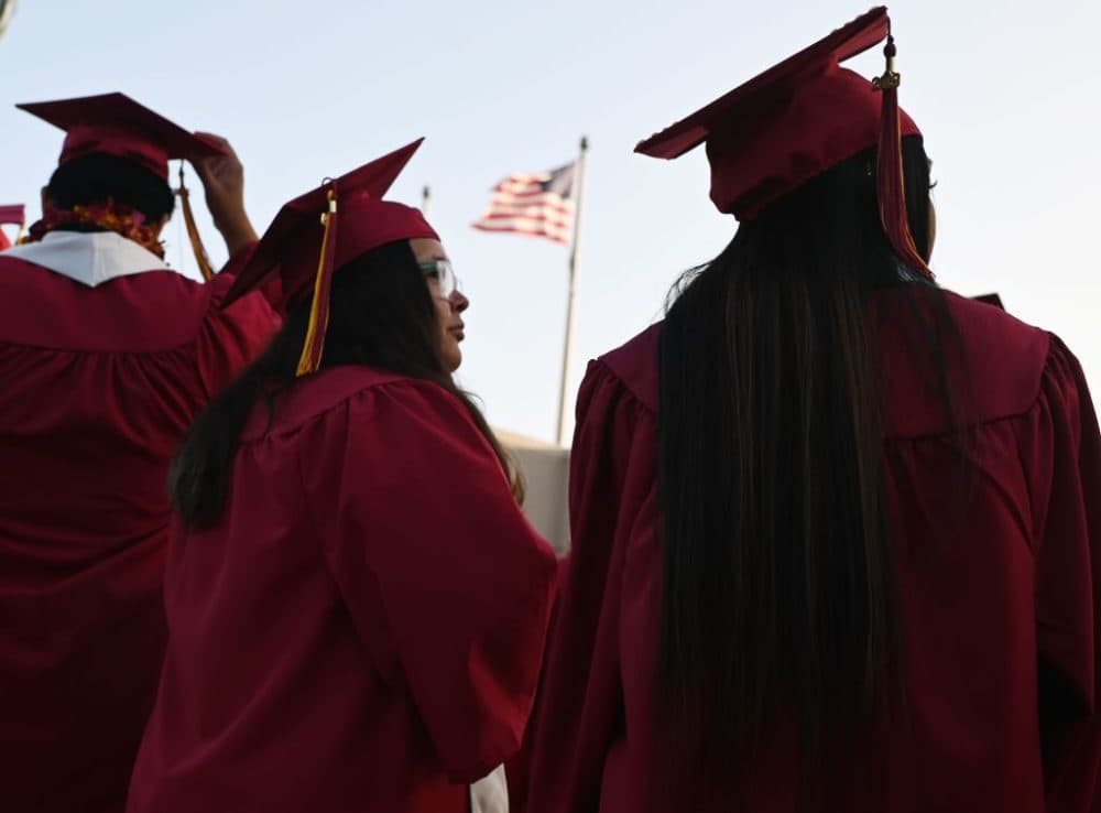 A U.S. flag flies above a building as students earning degrees at Pasadena City College participate in the graduation ceremony, June 14, 2019, in Pasadena, California. (Robyn Beck/AFP/Getty Images)