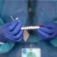 A nurse practitioner administers COVID-19 tests in a parking lot in Brockton, Massachusetts. (David L. Ryan/The Boston Globe via Getty Images)