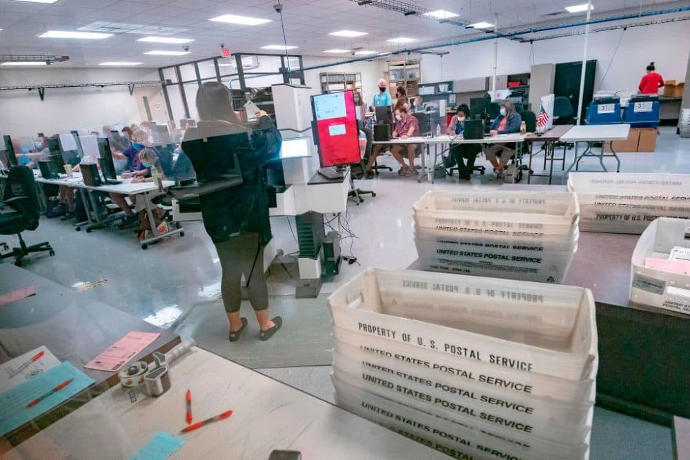Poll workers count ballots inside the Maricopa County Election Department in Phoenix, Arizona on November 5, 2020. (Olivier Touron/AFP via Getty Images)