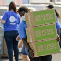 Quinton Robinson carries a stack of boxes from Feed The Children.At the Hope Rescue Mission in Reading, PA on August 27, 2020 where a food distribution was held from Feed the Children, in cooperation with Price Rite Marketplace, and Hope Rescue Mission. Families received boxes of food, personal care items, and two backpacks with school supplies. The distribution was done to meet the heightened need during the COVID-19 outbreak. (Ben Hasty/MediaNews Group/Reading Eagle via Getty Images)