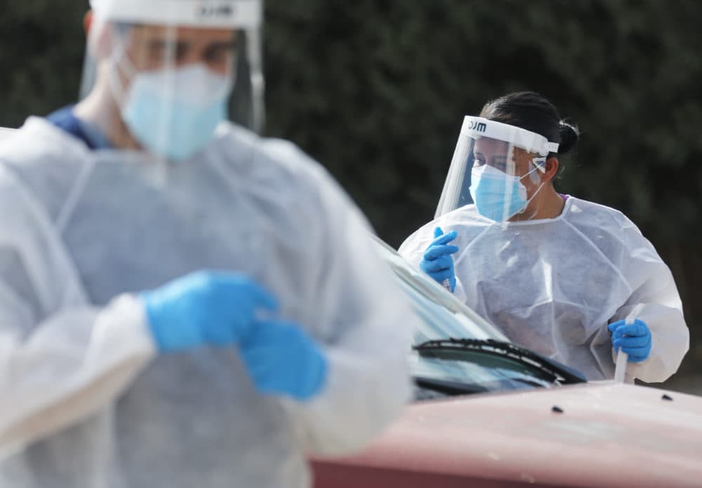 Frontline healthcare workers work at a drive-in COVID-19 testing site amid a surge of COVID-19 cases in El Paso on November 13, 2020. (Mario Tama/Getty Images)