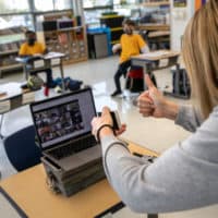 Third grade teacher Cara Denison speaks to students while live streaming her class via Google Meet at Rogers International School on November 19, 2020 in Stamford, Connecticut. Due to the coronavirus pandemic, most children in Stamford Public Schools attend alternate days of distance learning and in-class participation as part of the school district's hybrid education model. A smaller percentage of students distance learn full-time at home due to families' Covid-19 concerns. (John Moore/Getty Images)