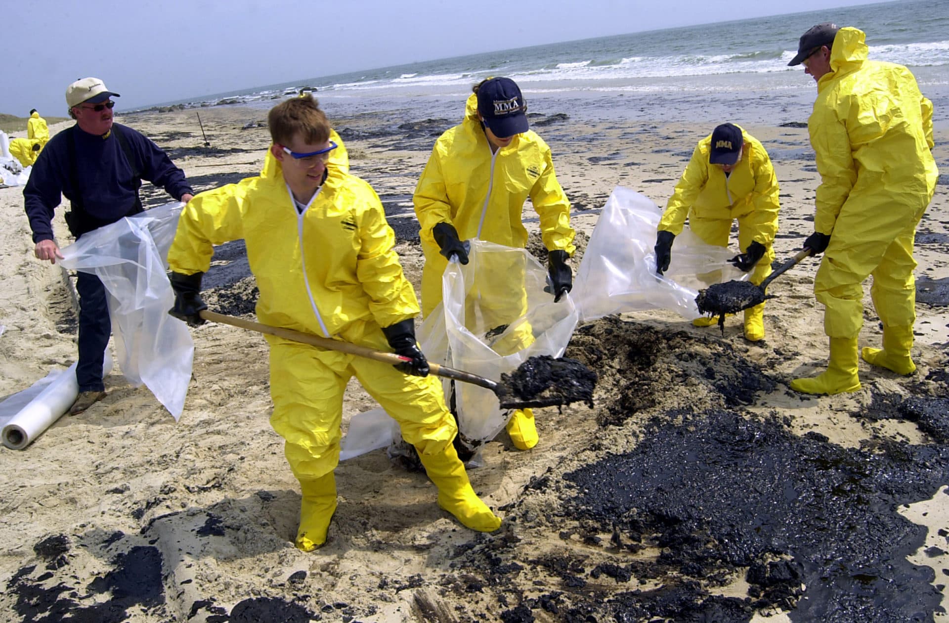 Personnel with Clean Harbors, Inc., remove oil from Barneys Joy beach on April 28, 2003, in Dartmouth, Massachusetts. (Douglas McFadd/Getty Images)