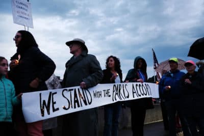Dozens of Connecticut residents converge along a bridge at a vigil and rally for the environment and against President Trump's recent decision to withdraw the United States from the Paris climate accord on June 4, 2017 in Westport, Connecticut. (Spencer Platt/Getty Images)
