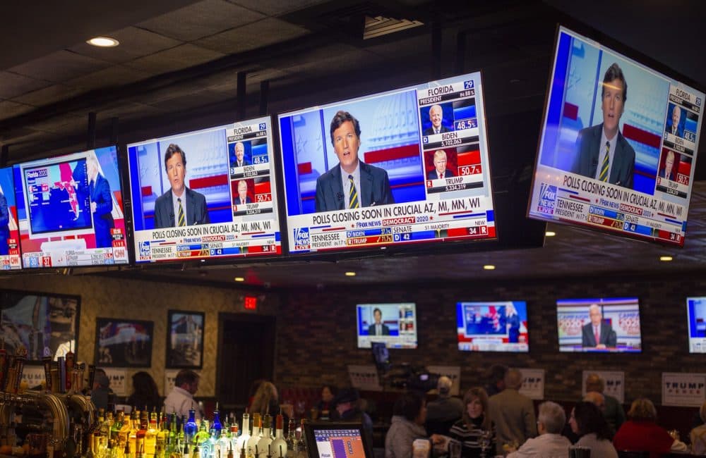 Televisions play election coverage at a watch party for President Donald Trump in Weymouth. (Joe Difazio for WBUR)