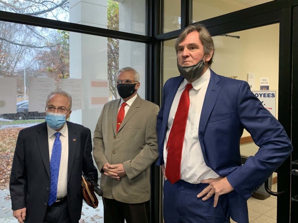Somerville police officer Michael McGrath, center, flanked by his defense attorneys after his arraignment in Cambridge District Court (Ally Jarmanning/WBUR)