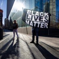 Black Lives Matter rally participants stand near the Government Center MBTA station in Boston. (Jesse Costa/WBUR)