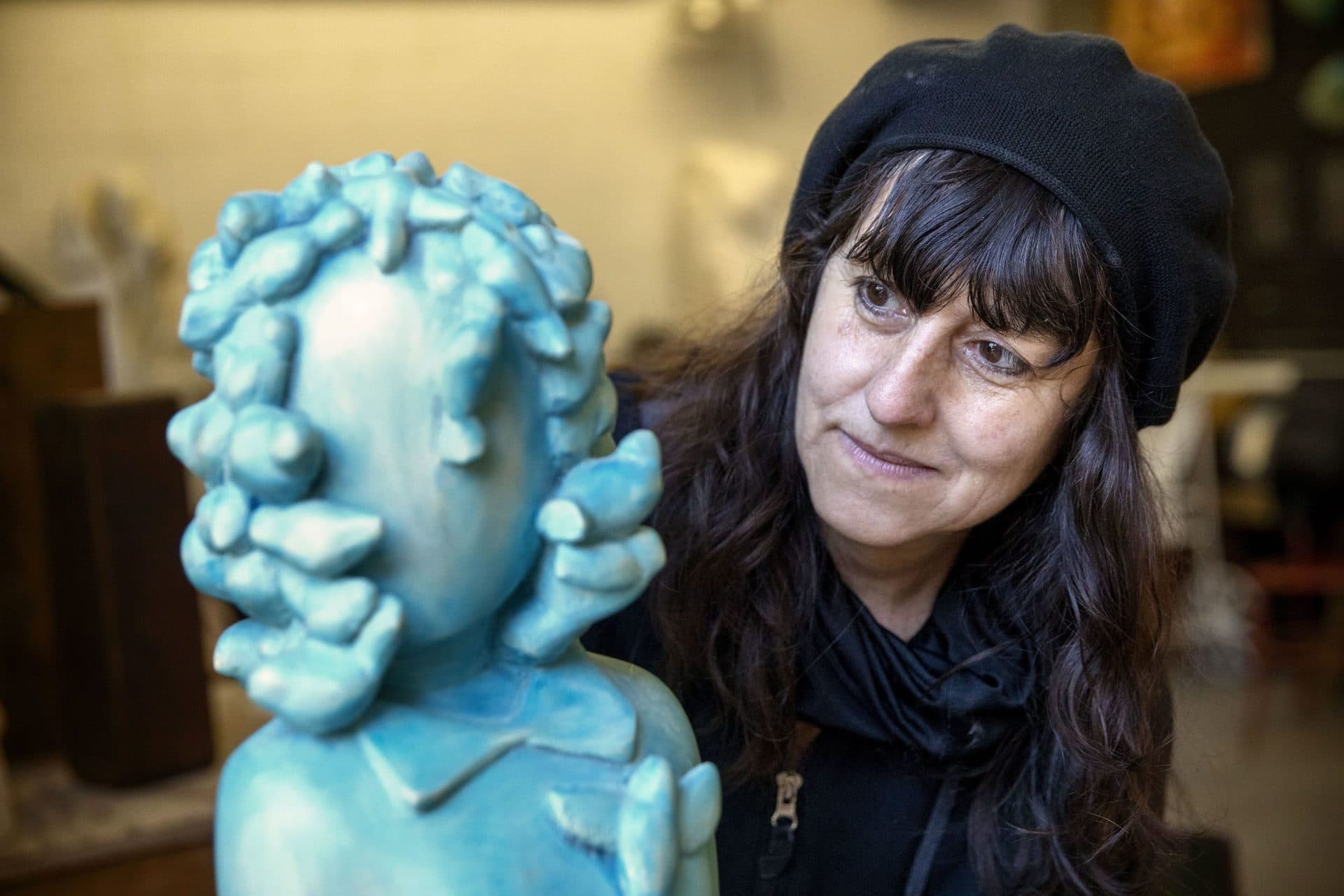 Sculptor Nora Valdez with "Singing Birds" at her workshop at Humphreys Street Studios in Dorchester, Mass. (Robin Lubbock/WBUR)