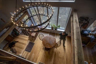WBUR reporter Simón Ríos walks around the dining area of the barn he recently restored. (Jesse Costa/WBUR)