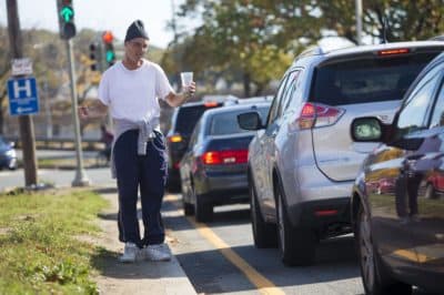 A man panhandles on Revere Beach Parkway in Everett. (Jesse Costa/WBUR)