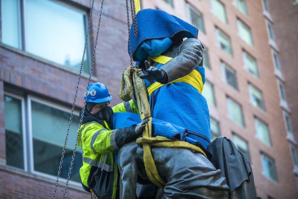 A worker ties up the statue to prepare it for removal from its pedestal in Park Square. (Jesse Costa/WBUR)