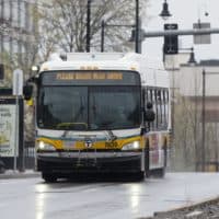 An MBTA bus runs along Commonwealth, Ave., April 24, 2020, in Boston. (Michael Dwyer/AP)