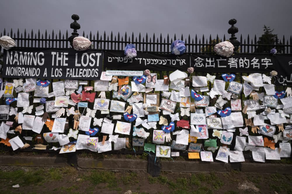 A fence outside Brooklyn's Green-Wood Cemetery is adorned with tributes to victims of COVID-19 in New York. The memorial is part of the Naming the Lost project which attempts to humanize the victims who are often just listed as statistics. (Mark Lennihan/AP)