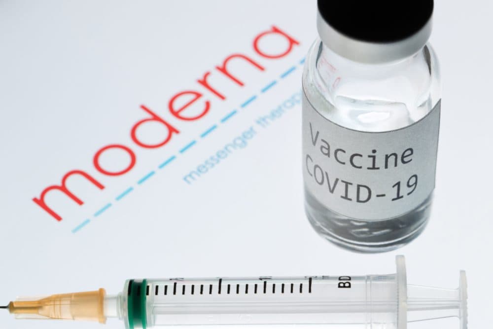 A syringe and a bottle reading "Vaccine COVID-19" next to the Moderna biotech company logo. (Joel Saget/AFP via Getty Images)