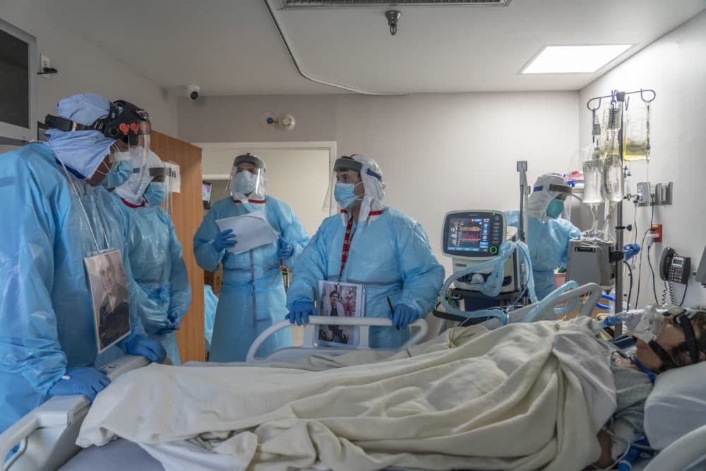 Medical staff members discuss as they check up on a patient in the COVID-19 intensive care unit at the United Memorial Medical Center on Dec. 4, 2020 in Houston, Texas. (Photo by Go Nakamura/Getty Images)