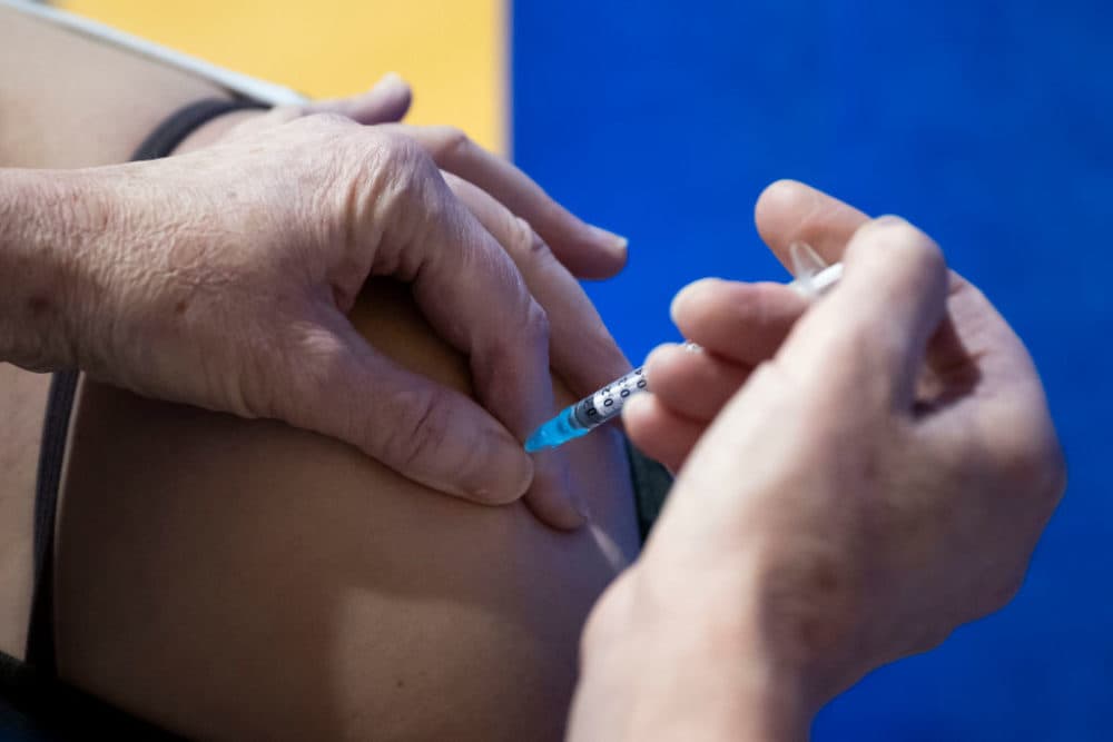 A coronavirus vaccination is given at Cardiff and Vale Therapy Centre on December 8, 2020, in Cardiff, Wales. More than 50 hospitals across U.K. were designated as COVID-19 vaccine hubs, the first stage of what will be a lengthy vaccination campaign. (Matthew Horwood/Getty Images)