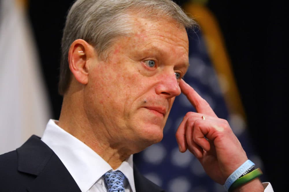 Gov. Charlie Baker wipes his eye after saying "I haven't had a meal with my Dad since February" during a press conference in the Gardner Auditorium in the Massachusetts State House in Boston on Dec. 7, 2020. (Pat Greenhouse/The Boston Globe via Getty Images)