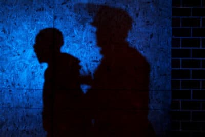 The shadow of a Louisville Police officers arresting a demonstrator is seen on a wall on September 23, 2020 in Louisville, Kentucky. (Michael M. Santiago/Getty Images)