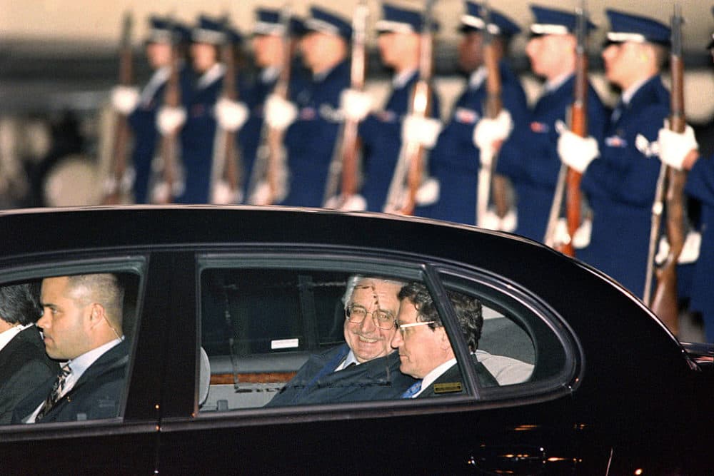 Croatian President Franjo Tuđman (C) and Richard Holbrooke (R) talk inside their limousine after Tuđman's arrival on Wright-Patterson Air Force Base on Oct. 31 to attend the Balkan peace talks. (Paul J. Richards/AFP/Getty Images)