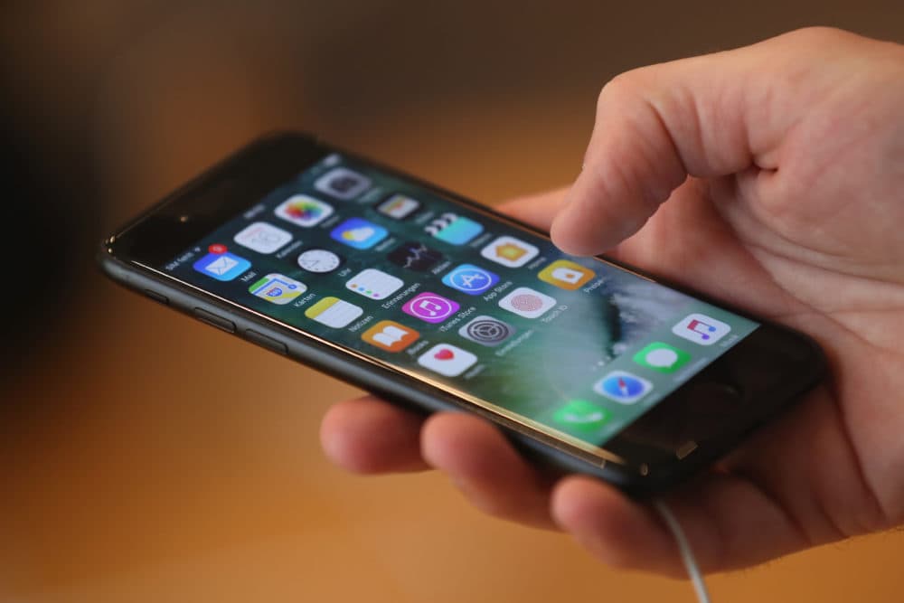 A person holds an Apple iPhone 7. (Sean Gallup/Getty Images)