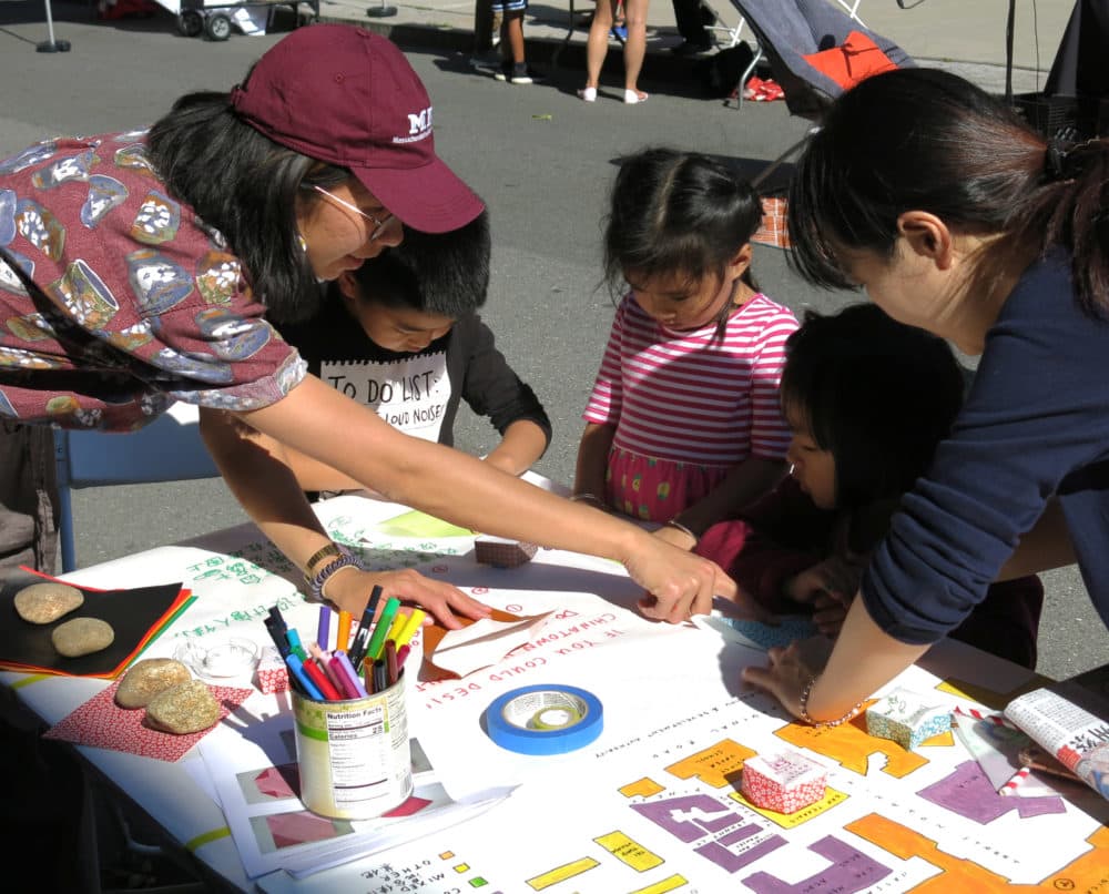 Artist and $40,000 grantee Lily Xie directing youth to place origami houses onto a map of Chinatown as part of the project Mapping Chinatown. (Courtesy)