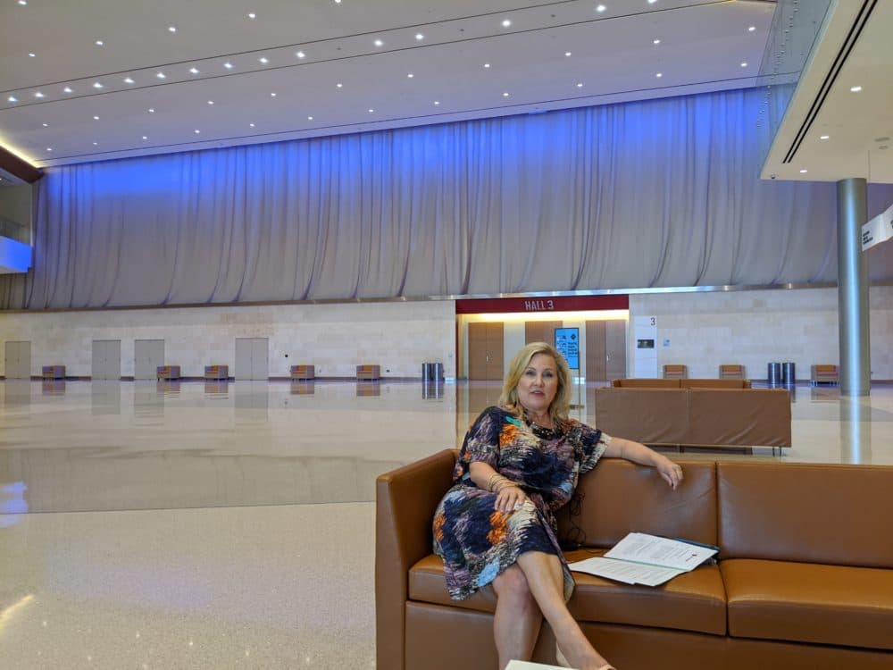 Casandra Matej, president and CEO of Visit San Antonio sits inside an empty foyer of the Henry B. González Convention Center on Aug. 4, 2020. (Paul Flahive, TPR)