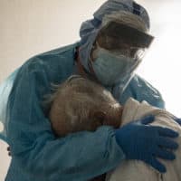 Dr. Joseph Varon hugs and comforts a patient in the COVID-19 intensive care unit during Thanksgiving at the United Memorial Medical Center on November 26, 2020 in Houston, Texas. (Photo by Go Nakamura/Getty Images)