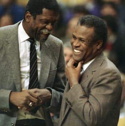 In this Jan. 15, 1988, file photo, former Boston Celtics teammates Bill Russell, Sacramento Kings coach, left, and K.C. Jones, Celtics coach, meet before the start of the Kings-Celtics NBA basketball game at the Boston Garden in Boston. (Mike Kullen/AP)