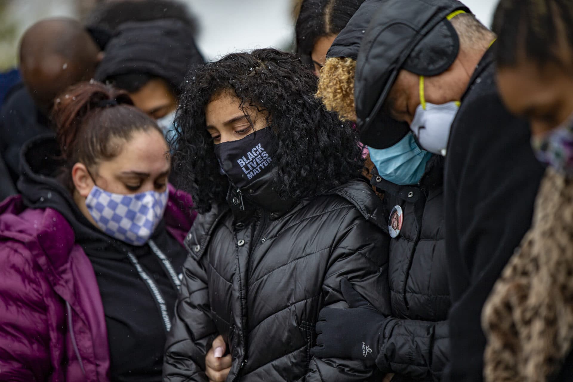 Henry Tapia’s 15-year-old daughter, Sophia, stands among family and friends during her father's burial. (Jesse Costa/WBUR)