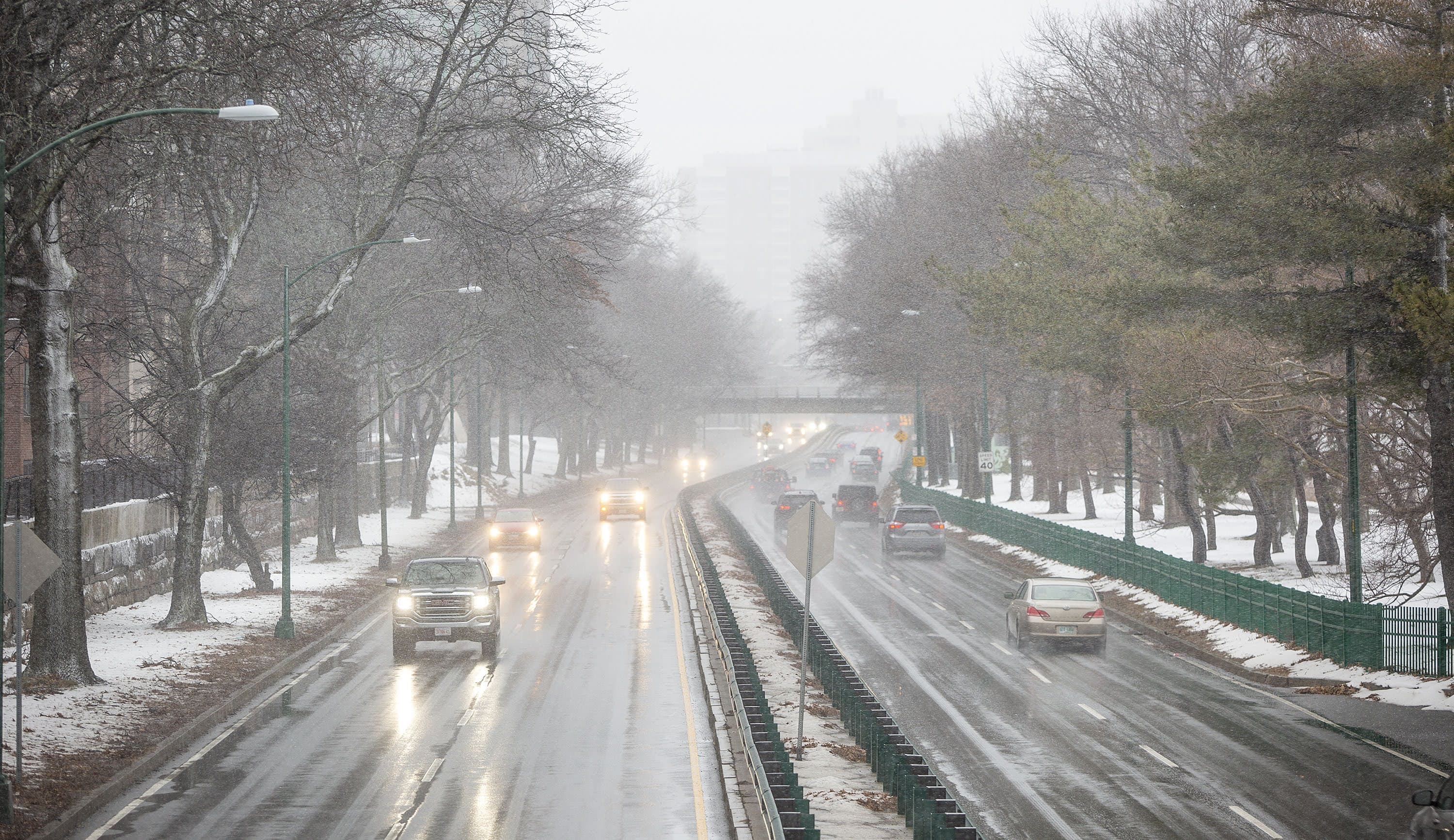 Snow falling on Storrow Drive Monday afternoon as the nor'easter moves into Boston. (Robin Lubbock/WBUR)