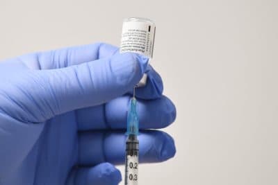  A needle and a phial of Pfizer-BioNTech COVID-19 vaccine are used to prepare a dose. (Justin Tallis/AFP via Getty Images)