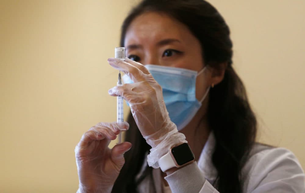 Donna Ko, pharmacist for CVS, prepares the Pfizer-BioNTech COVID-19 vaccine to give to veterans at the Soldier's Home in Chelsea, MA on Dec. 29, 2020. (Jessica Rinaldi/The Boston Globe via Getty Images)