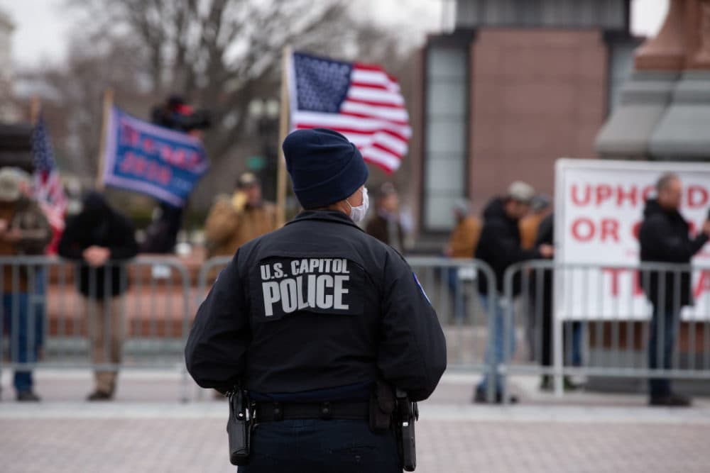 A Capitol Police officer watches supporters of U.S. President Donald Trump gather outside the U.S. Capitol on January 6, 2021 in Washington, DC. (Cheriss May/Getty Images)