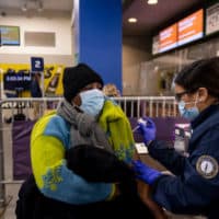 A patient receives the Pfizer vaccine as the ballpark is opened as a COVID-19 public vaccination site on January 29, 2021 at Fenway Park in Boston, Massachusetts. (Billie Weiss/Boston Red Sox/Getty Images)
