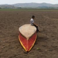A boy sits on an abandoned boat on what is left of Lake Atescatempa, which has dried up due to drought and high temperatures, in Atescatempa, 174 km southeast of Guatemala City, on May 5, 2017. - ( Marvin Recino/AFP via Getty Images)