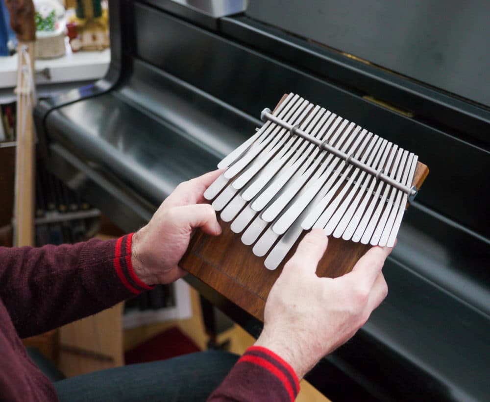 Composer Eric Shimelonis playing the mbira. (courtesy of Rebecca Sheir)