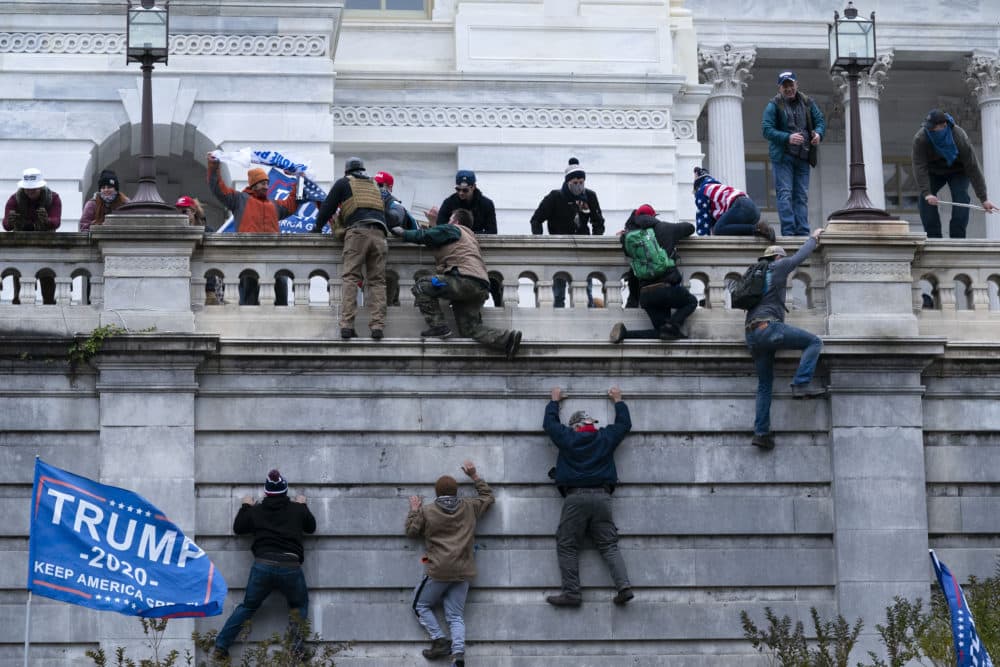 Supporters of President Trump climb the West wall of the U.S. Capitol on Jan. 6. (Jose Luis Magana/AP)
