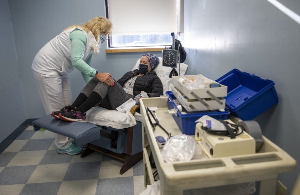 Nurse Liz Rekowski keeps a close eye on Crystal Alderfer when she reports feeling unwell after her vaccination. (Robin Lubbock/WBUR)