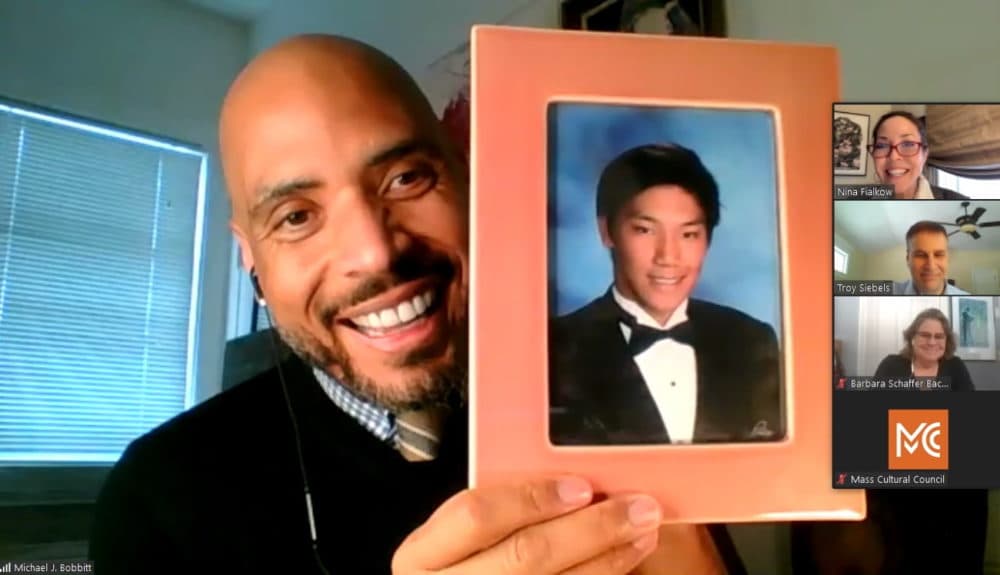 Michael Bobbitt during a Zoom call in December 2020 with the Mass Cultural Council's governing board. During the call, he held up a photo of his son, Sang. (Screenshot/State House News Service)