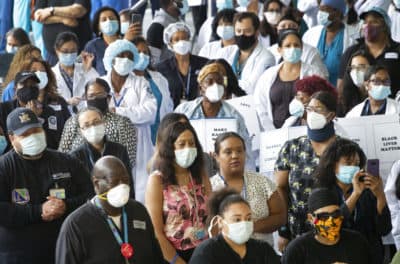 Health care workers at Brooklyn's Kings County Hospital show their solidarity with the Black Lives Matter movement, Thursday, June 4, 2020 in New York during the coronavirus pandemic. (AP Photo/Mark Lennihan)