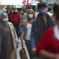 People wear face masks as they walk through the city center in Munich, Germany, Thursday, Sept. 24, 2020. (Matthias Schrader/AP)