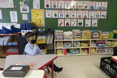 Students wear a face masks and are seated at a proper distance from their classmates in a kindergarten class.(Mary Altaffer/AP)