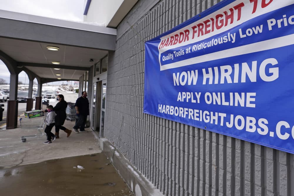 In this Dec. 10, 2020 file photo, a "Now Hiring" sign hangs on the front wall of a Harbor Freight Tools store in Manchester, N.H. (Charles Krupa/AP File)