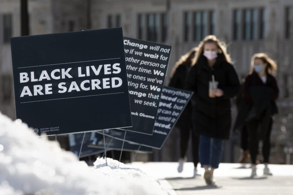 Students walk past Black History Month posters on the Boston College campus, Wednesday, Feb. 17, 2021, in Boston. (Michael Dwyer/AP)
