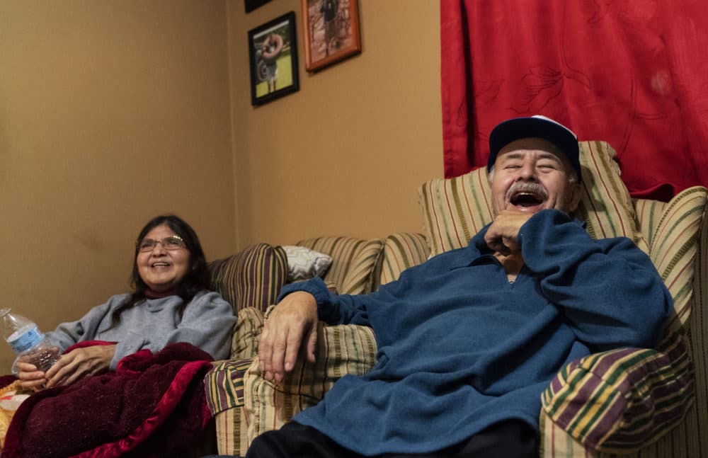 Mario Valdez, 62, right, laughs while watching television with his wife, Reyna, 52, at their home in Central Falls, R.I., Feb. 18, 2021. "(David Goldman/AP)