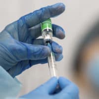 A medic prepares to administer a dose of an AstraZeneca COVID-19 vaccine. (Kyiv's City Hall Press Office via AP)